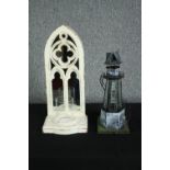 A modern mirror backed wall mounted candle holder with a scratch built looking lighthouse candle