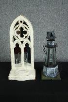 A modern mirror backed wall mounted candle holder with a scratch built looking lighthouse candle