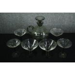 A Swedish smokey etched glass spherical decanter with conical stopper and four matching glasses