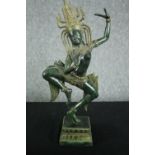 A Khmer style bronze figure of Apsara in a dance pose on a lotus form base. H.42cm.