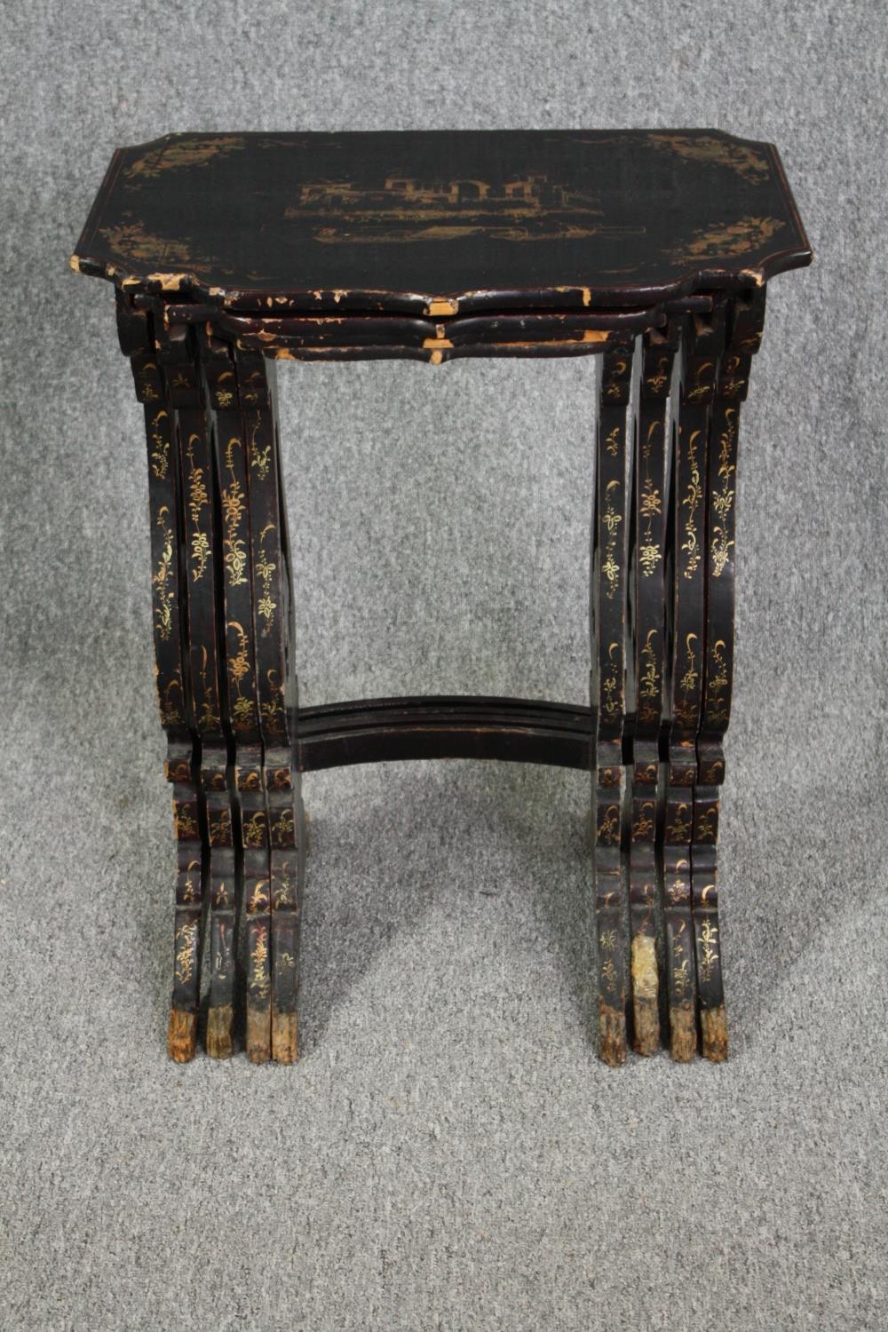 A nest of of four graduating occasional tables, mid century lacquered with Chinoiserie decoration.