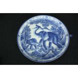 A 20th century blue and white elephant design plate. (has hole with handle attached). Dia.36cm.