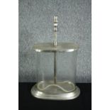 A glass table lamp. With an extending stem. Chromed metal and glass. With a loose rubber seal.