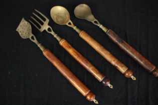 A set of vintage brass cooking utensils. L.47cm. (Largest).