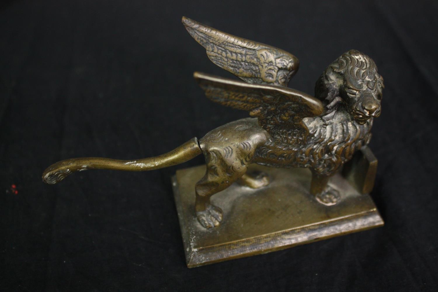 An Indian silver plated repousse mirror, a brass winged lion, a gilt bronze bowl stand and a pair of - Image 6 of 7