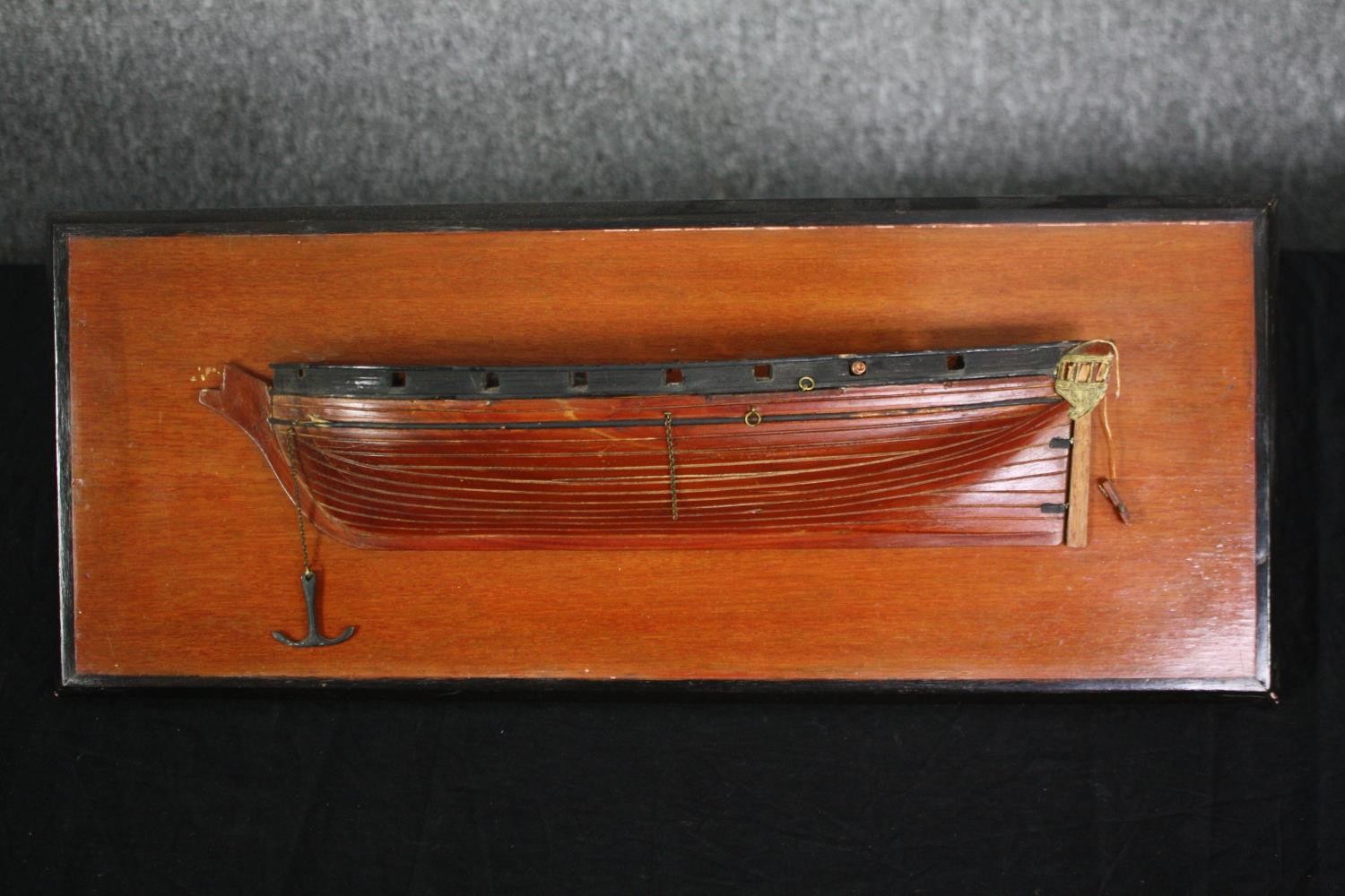 A scratch built model of a boat hull on a wall mounting panel. H.20 W.49cm.