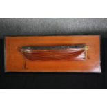 A scratch built model of a boat hull on a wall mounting panel. H.20 W.49cm.