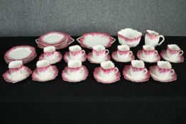 A 19th century hand painted 12 person part tea set with pink and gold foliate and hummingbird