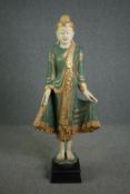 A floor standing Cambodian buddha statue, carved gilded and painted and inset with mirrored mosaic