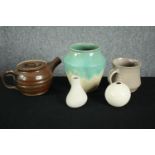 A mixed collection of pottery including a teapot with a flared spout, a jug, and three vases. The