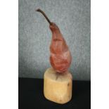 Contemporary art, a carved and painted pear. H.34cm.