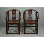 Armchairs, a pair of 19th century Chinese elm with horseshoe backs and carved splats on carved