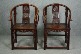 Armchairs, a pair of 19th century Chinese elm with horseshoe backs and carved splats on carved