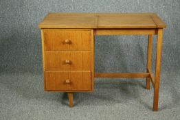 A mid century Meredew Furniture dressing table in light oak fitted with a rising vanity mirror. H.68
