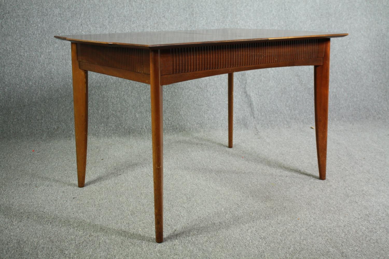 A mid century Waring and Gillow Ltd dining table. H.75 W.122 D.84cm. (The central leaf is missing - Image 3 of 7