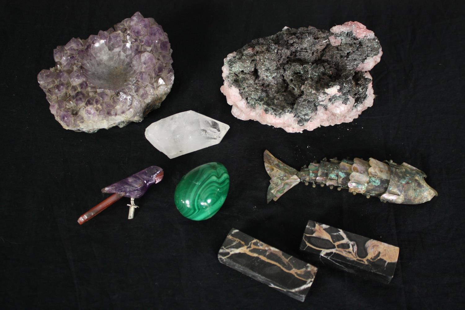 A miscellaneous collection: rhodochrosite crystal formations, a malachite egg, amethyst and