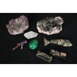 A miscellaneous collection: rhodochrosite crystal formations, a malachite egg, amethyst and