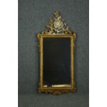 Wall mirror, late 19th century carved giltwood with Rococo scroll cresting. H.132 W.61cm.