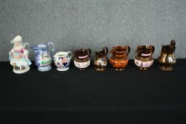 A 19th century character jug along with Lusterware examples etc. H.25cm. (Largest)
