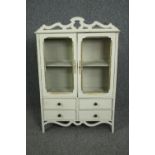 A wall hanging cabinet in the form of a dresser. painted Continental style. H.92 W.60 D.19cm.