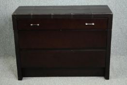 Chest of drawers, contemporary in faux leather cladding. H.80 W.108 D.40cm. (Some wear as seen).