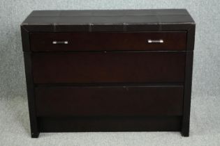 Chest of drawers, contemporary in faux leather cladding. H.80 W.108 D.40cm. (Some wear as seen).
