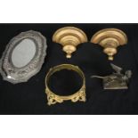 An Indian silver plated repousse mirror, a brass winged lion, a gilt bronze bowl stand and a pair of