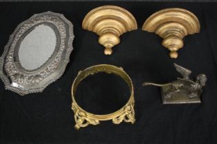 An Indian silver plated repousse mirror, a brass winged lion, a gilt bronze bowl stand and a pair of