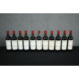 Eleven bottles of Mouton-Cadet Bordeaux. Ten are 1982 and one is 1986. H.30cm. (Each)
