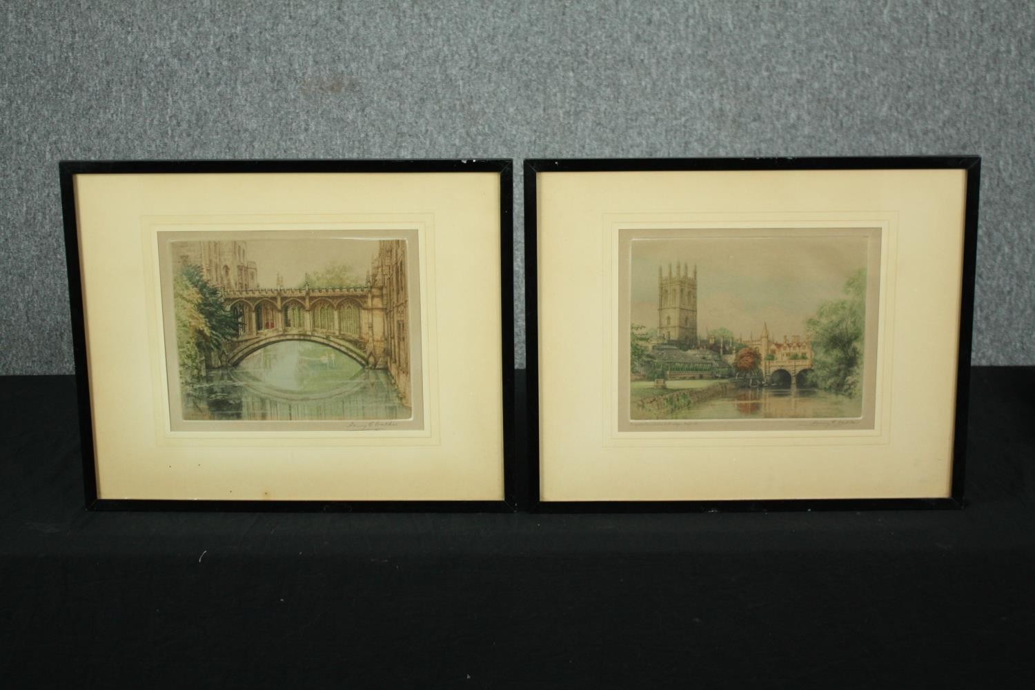 A pair of framed and glazed etchings, Magdalene Tower and Bridge, Oxford and another, signed in