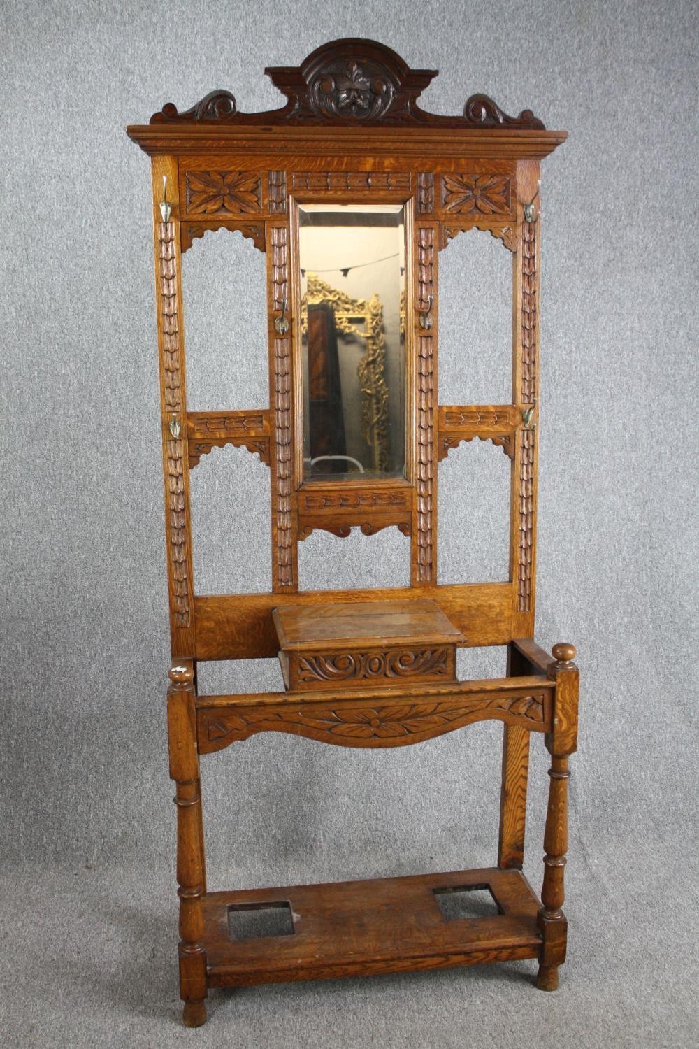 A Victorian period oak hall hat /coat and cane stand, dating from around 1890. With a shaped cornice
