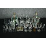 A collection of mixed 19th and 20th century glasses and bottles, including a pair of gilded cut