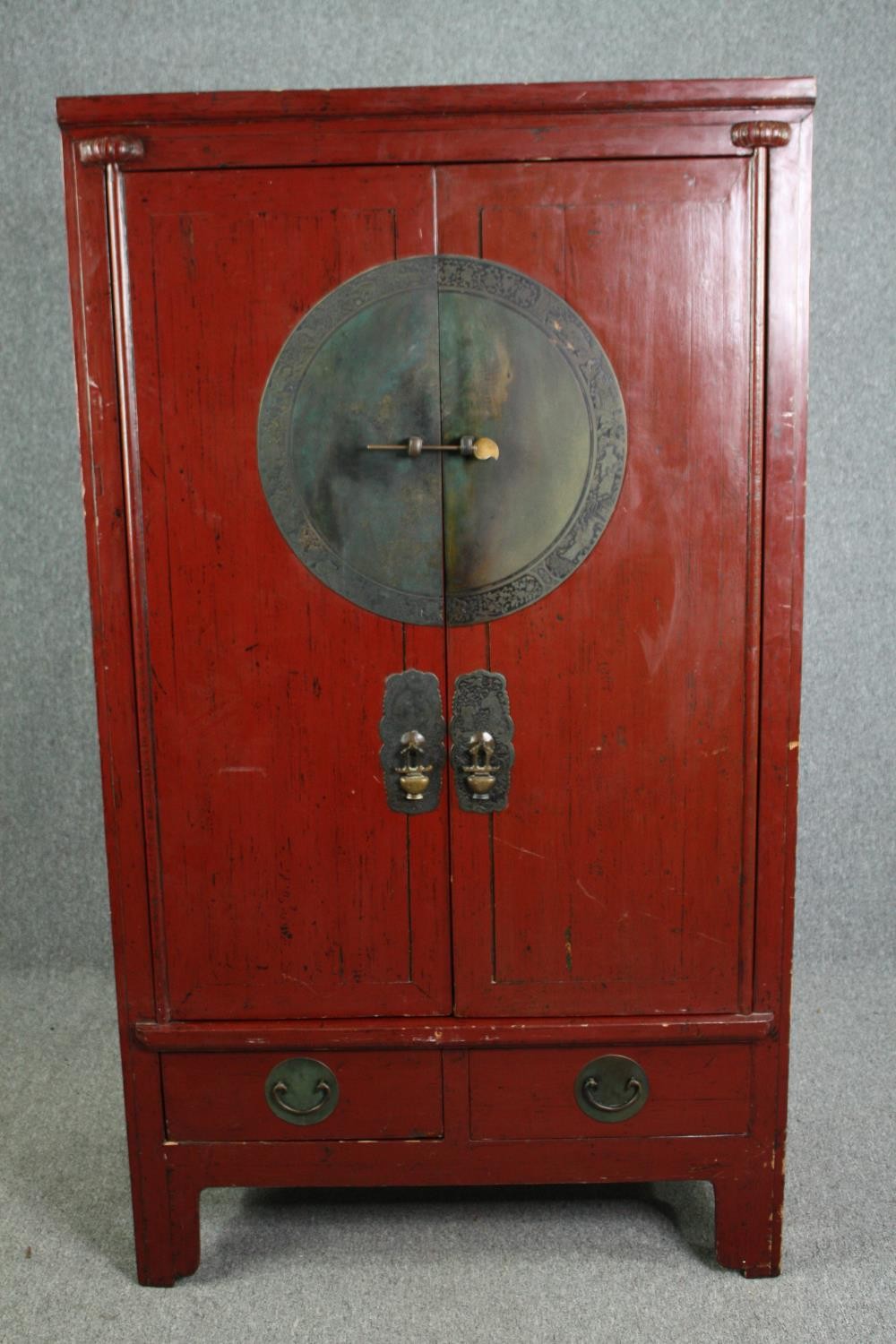 Hall cupboard, Chinese lacquered with incised bronze locking plate and fitted with base drawers. H.