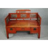 A 19th century Chinese window seat, lacquered polychrome and carved fitted with drawers to the base.