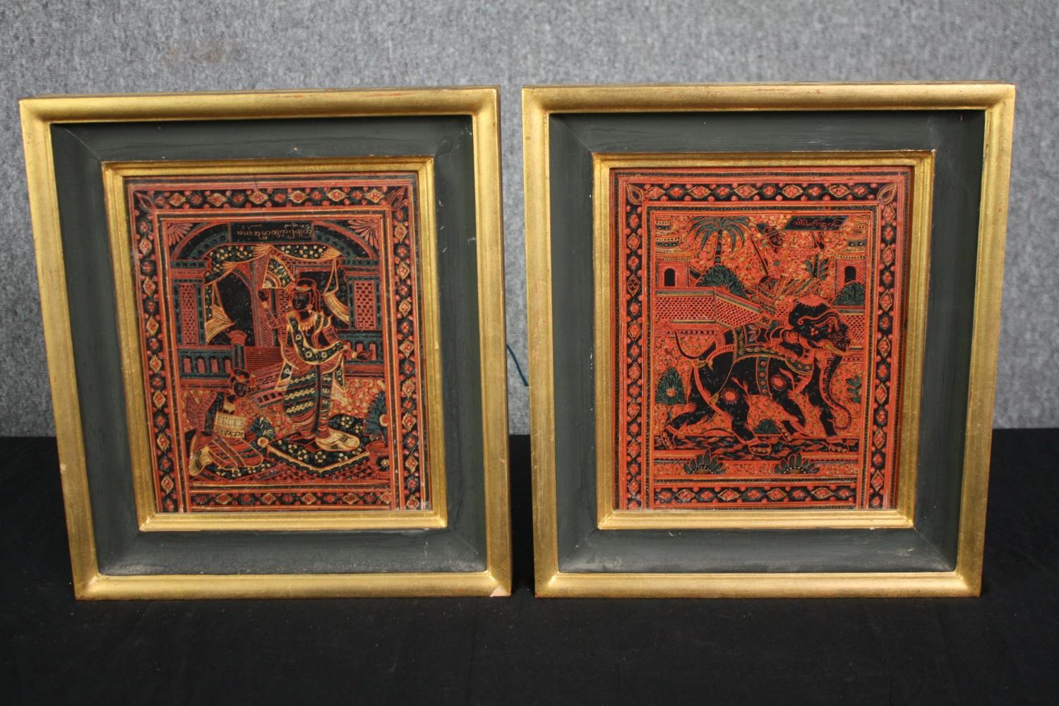A pair of etched and lacquered Thai panels in gilt frames. H.34 W.30cm. (Each).