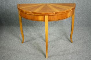 Tea table, late 19th century segment veneered birch with foldover top raised on slender cabriole