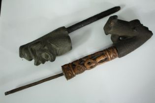 A Cameroon terracotta, metal and bone shaman's pipe along with a similar example. L.38cm. (Largest)