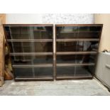 Bookcases, a pair mid century teak with plate glass sliding doors. H.121 W.89 D.23cm.