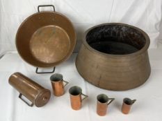 A collection of copper items; cooking vessels and measuring jugs. Largest H.20 W.45cm