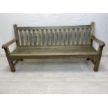 A vintage weathered teak garden bench. H.90 W.179 D.62cm.