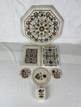 A collection of Indian pietra dura, a variety of semi- precious stones in white marble. Seven