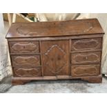 A late 18th or early 19th century French provincial carved chestnut bureau cabinet with fitted