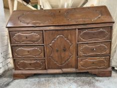 A late 18th or early 19th century French provincial carved chestnut bureau cabinet with fitted
