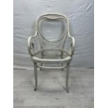 A late 19th century painted Thonet style armchair with scrolling arms and heart motif to the back.