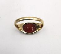 An early 20th century yellow metal (tests as higher than 9ct) and carnelian intaglio monogram signet