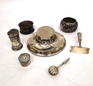 A collection of silver items, including a weighted silver inkwell (damaged), a silver shell napkin