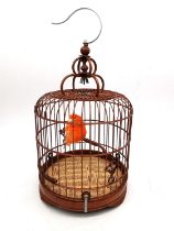 A vintage Chinese bamboo birdcage with taxidermy orange Canary inside. Label to base. H.35