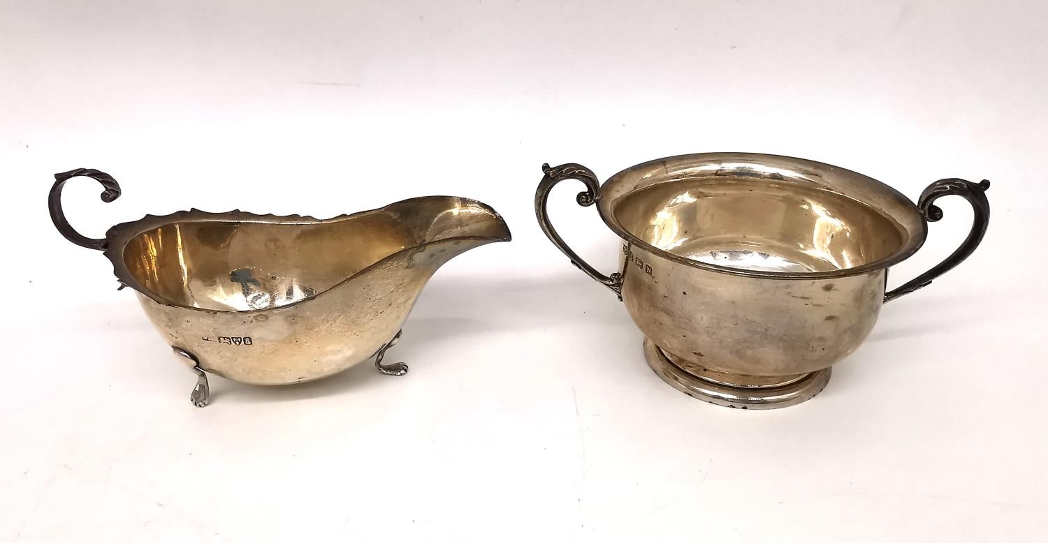 A Victorian silver gravy boat by William Neale along with a 1930s twin handled silver sugar bowl