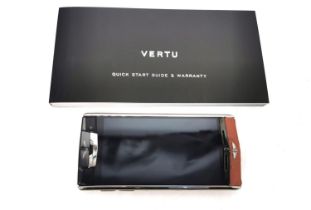 A boxed Vertu Signature touch Bentley mobile phone. The Vertu for Bentley is made from lightweight