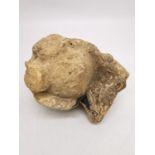 A carved limestone finial allegedly from Lincoln cathedral. H.18 W.16 D.13cm.